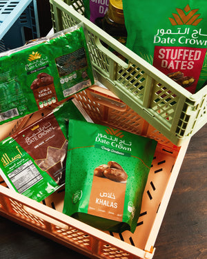 Basket with Date Crown stuffed dates packaging on a wooden surface